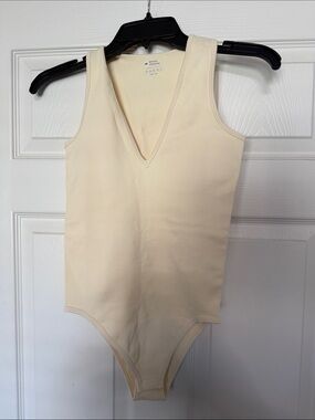 OQQ Woman’s Cream V-Neck Sleeveless One-Piece Bodysuit